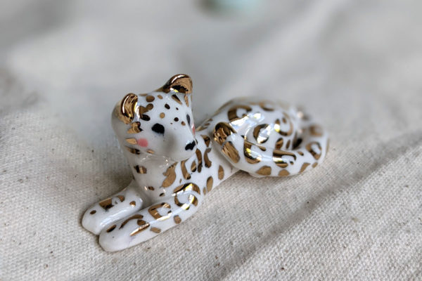 gold and porcelain snow leopard figurine