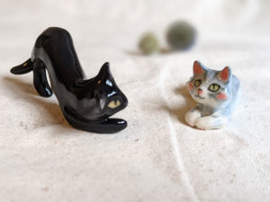 black cat, grey cat figurine