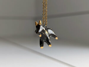 Black Phillip porcelain pendant with gold