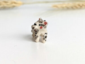snow leopard tail eating pendant porcelain kness