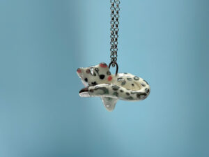 adorable snow leopard pendant tail in mouth