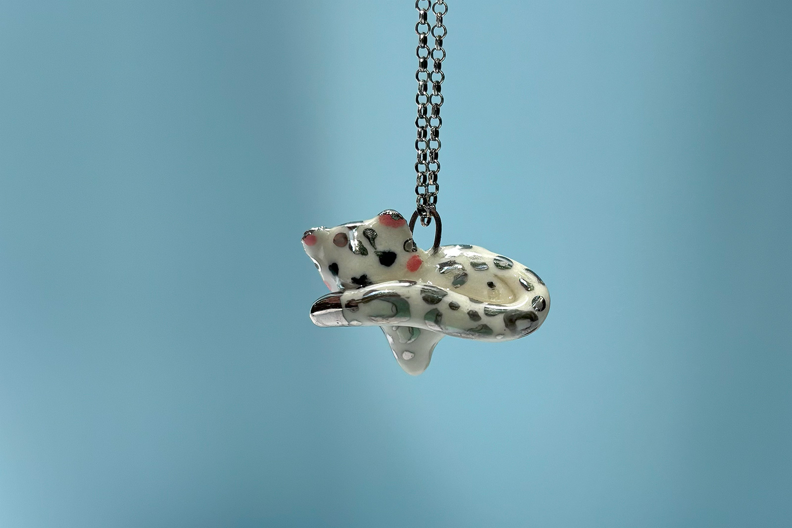 adorable snow leopard pendant tail in mouth