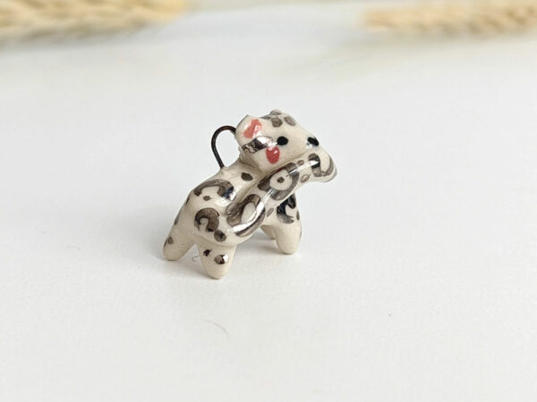 snow leopard tail eating pendant porcelain kness