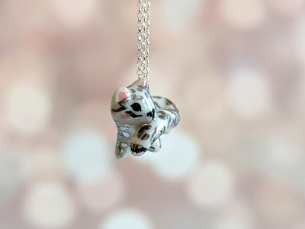 snow leopard tail eating pendant porcelain kness