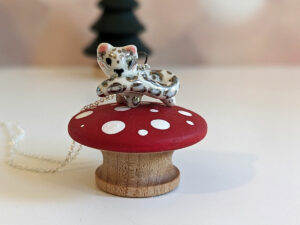 snow leopard tail eating pendant porcelain kness