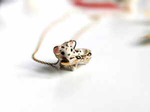 snow leopard tail eating pendant porcelain kness
