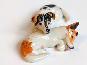 jack russel cuddling figurines