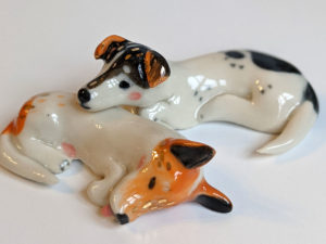 jack russel cuddling figurines