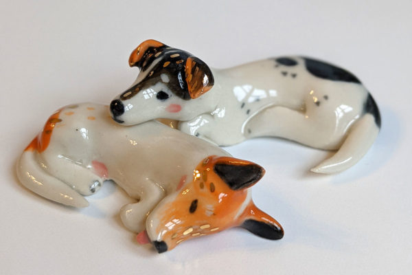 jack russel cuddling figurines