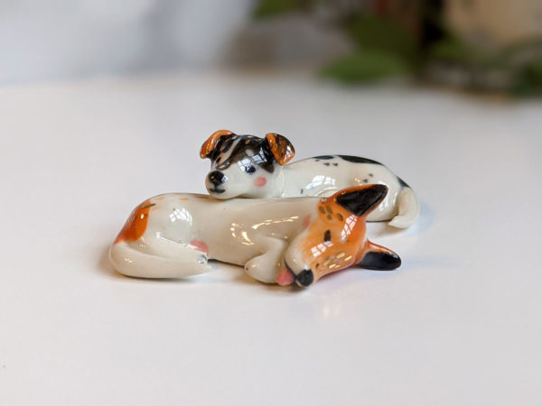 jack russel cuddling figurines