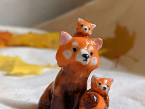 red panda family porcelain figurine