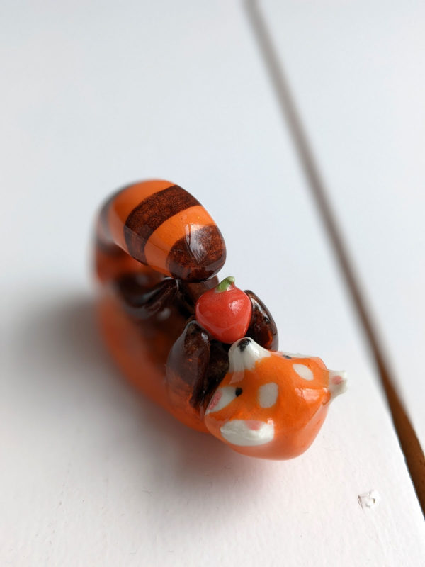 red panda and apple figurine