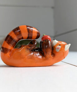 red panda and apple figurine