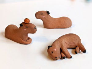 red clay capybara figurines group