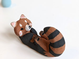 red clay ceramics figurine red panda holder