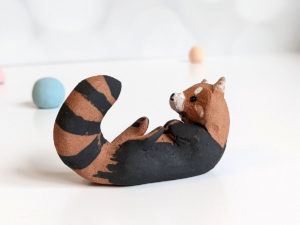 red clay ceramics figurine red panda holder