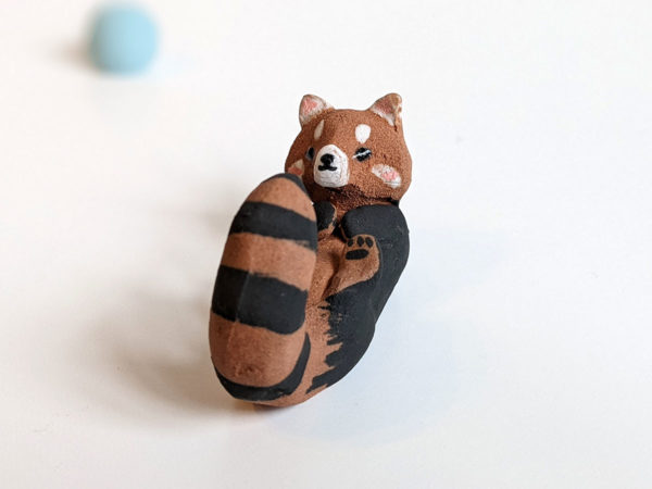 red clay ceramics figurine red panda holder