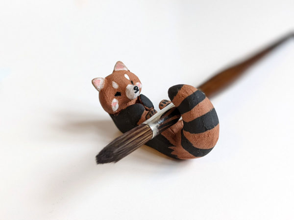 red clay ceramics figurine red panda holder