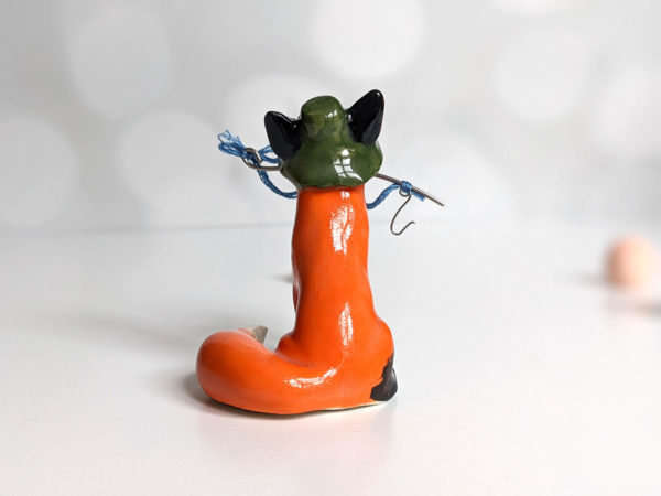 Fox figurine with fishing gear