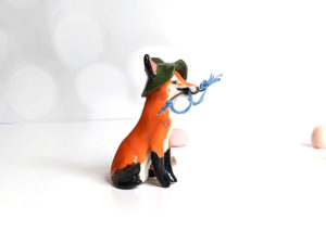 Fox figurine with fishing gear