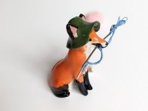 Fox figurine with fishing gear