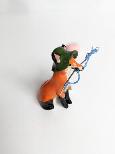Fox figurine with fishing gear