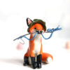 Fox figurine with fishing gear