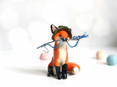 Fox figurine with fishing gear