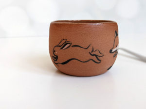 handmade fox hare red clay cup