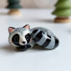 sleepy raccoon porcelain figurine