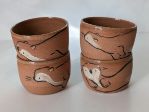 cute otter tumbler handmade in red clay kness