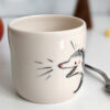 white porcelain opossum tumbler