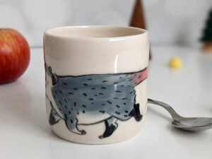 white porcelain opossum tumbler