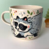 mug raccoon family