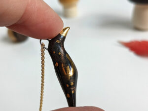 porcelain pendant crow gold