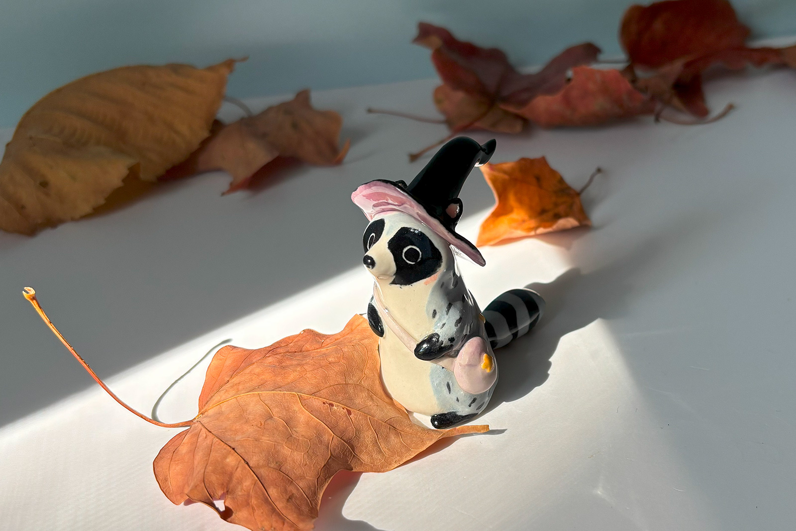 raccoon witch porcelain figurine
