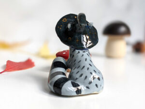 raccoon witch porcelain figurine