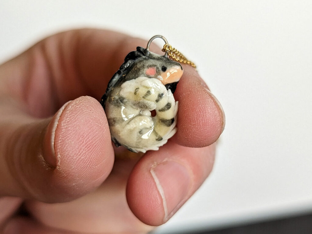 a pet iguana portrait as a porcelain pendant 