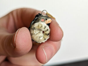 a pet iguana portrait as a porcelain pendant
