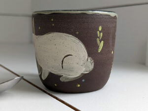 black stoneware mug with bunnies