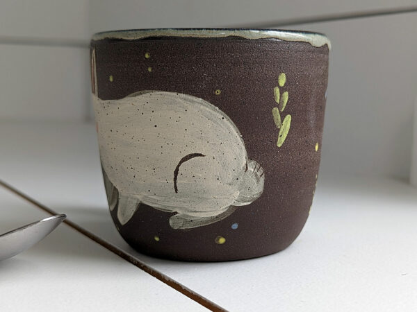 black stoneware mug with bunnies