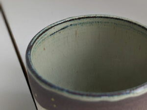black stoneware mug with bunnies