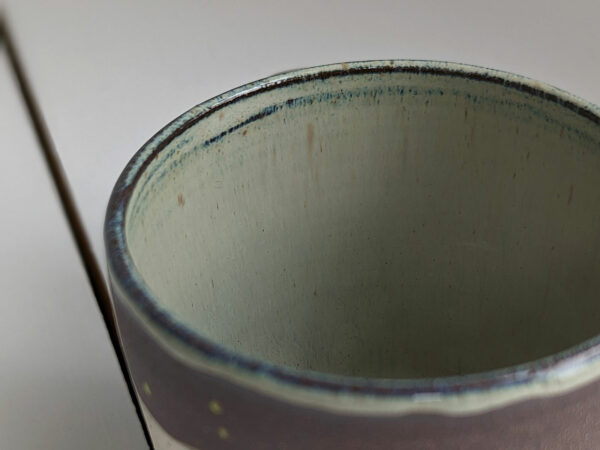 black stoneware mug with bunnies