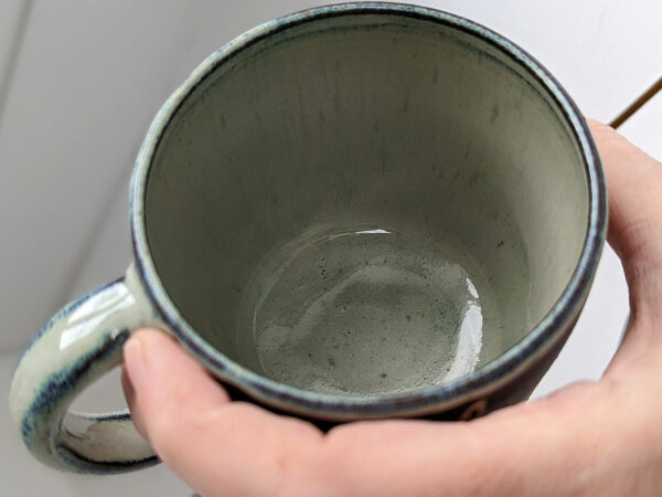 black stoneware mug with bunnies