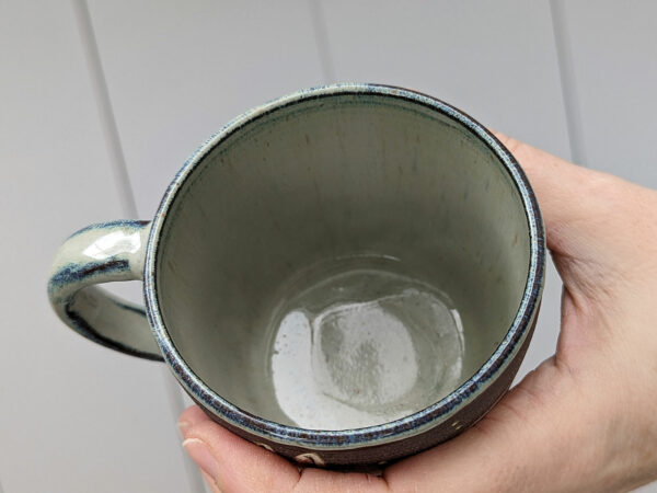 black stoneware mug with bunnies