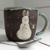 black stoneware mug with bunnies