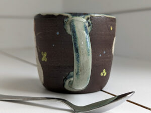 black stoneware mug with bunnies
