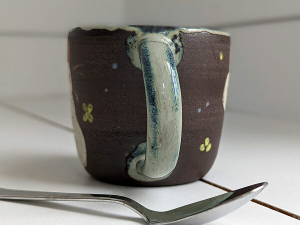 black stoneware mug with bunnies