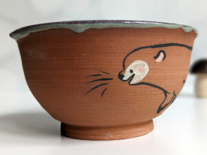 cute otter bowl for matcha in red clay and blue glaze