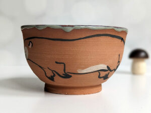 cute otter bowl for matcha in red clay and blue glaze